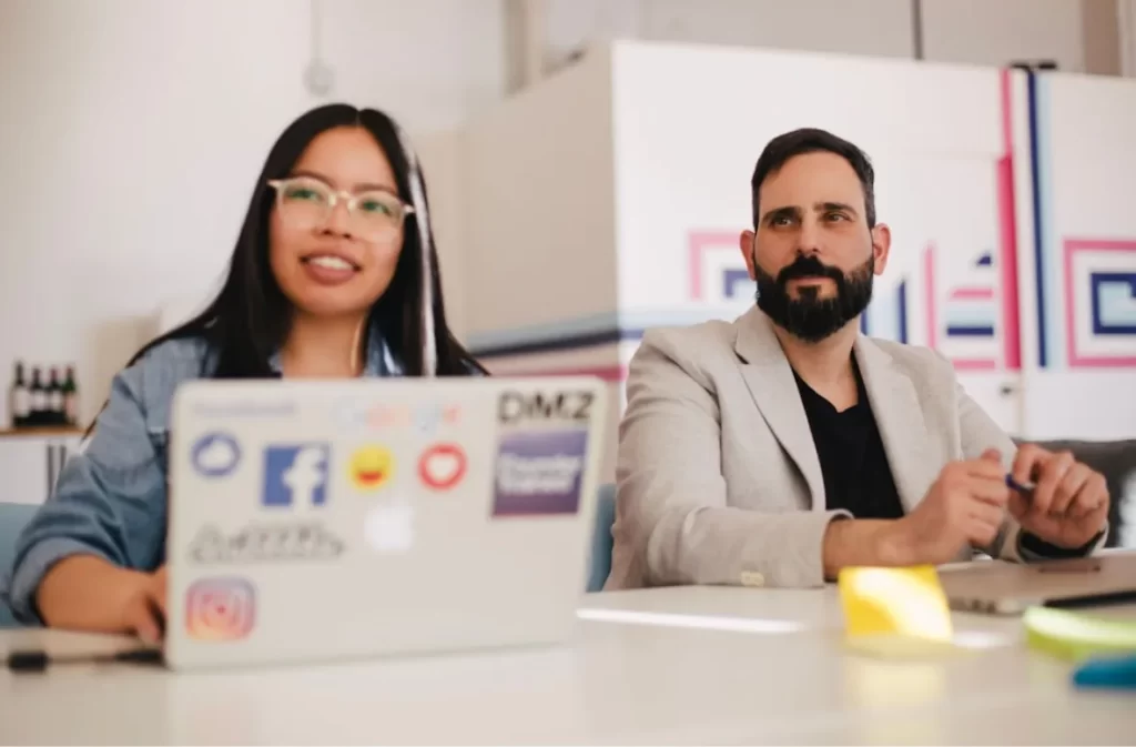 Two people working together with laptops.