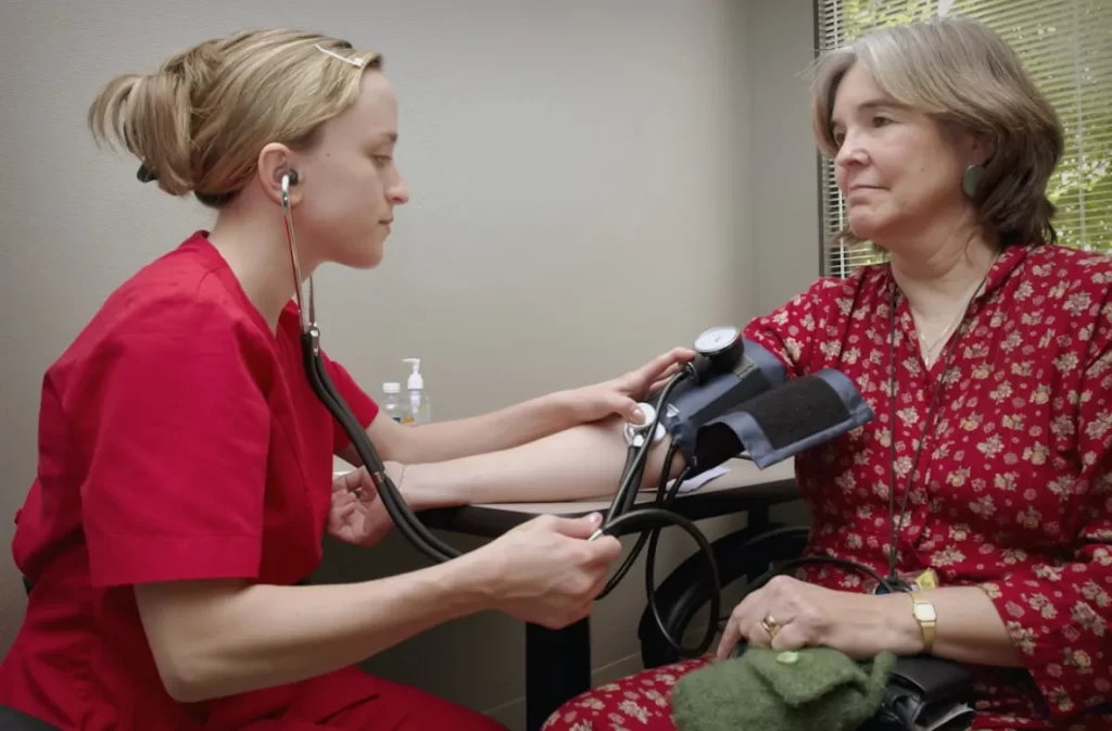 Nurse performing blood pressure check calmly